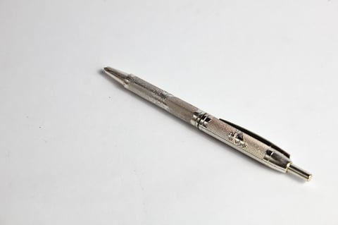 Silver ballpoint pen isolated on white