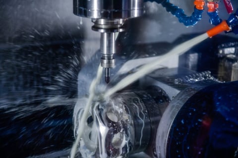 CNC milling machine cutting the mold parts with oil coolant method