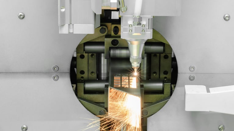 Close up scene the fiber laser cutting machine cutting the stainless steel tube. The hi-technology sheet metal manufacturing process by laser cutting machine