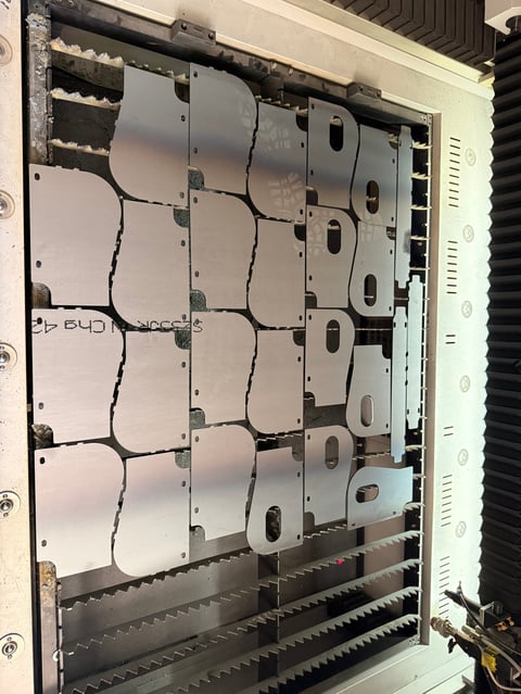 Inside view of server rack with multiple white modular power supply units mounted vertically with cable connections